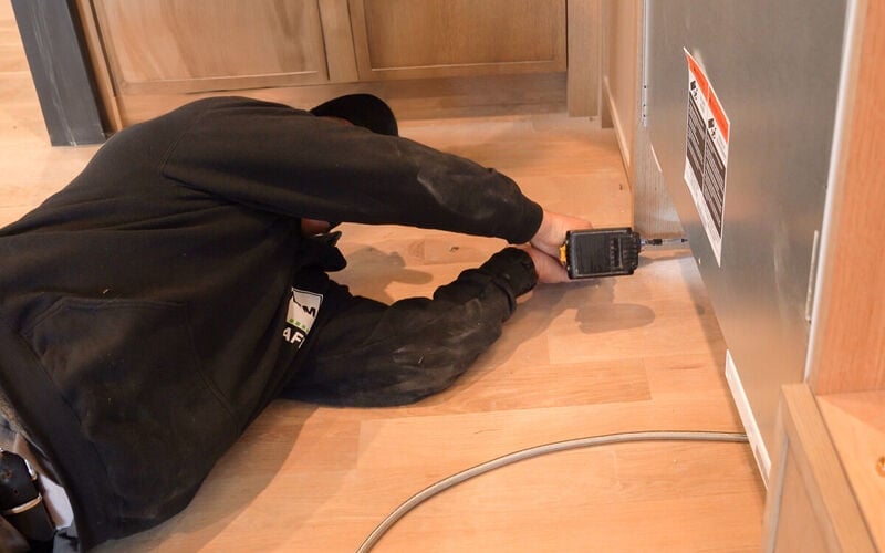 Contractor Installing an Appliance in Customer's Home